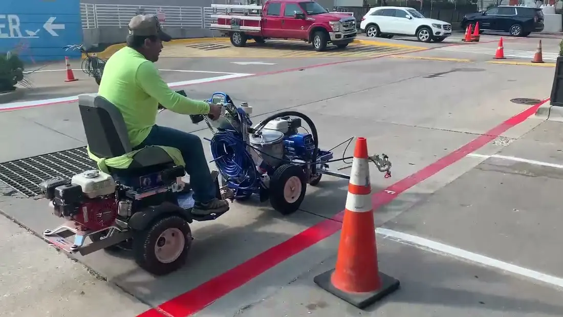Faded commercial parking lot restriping example after winter